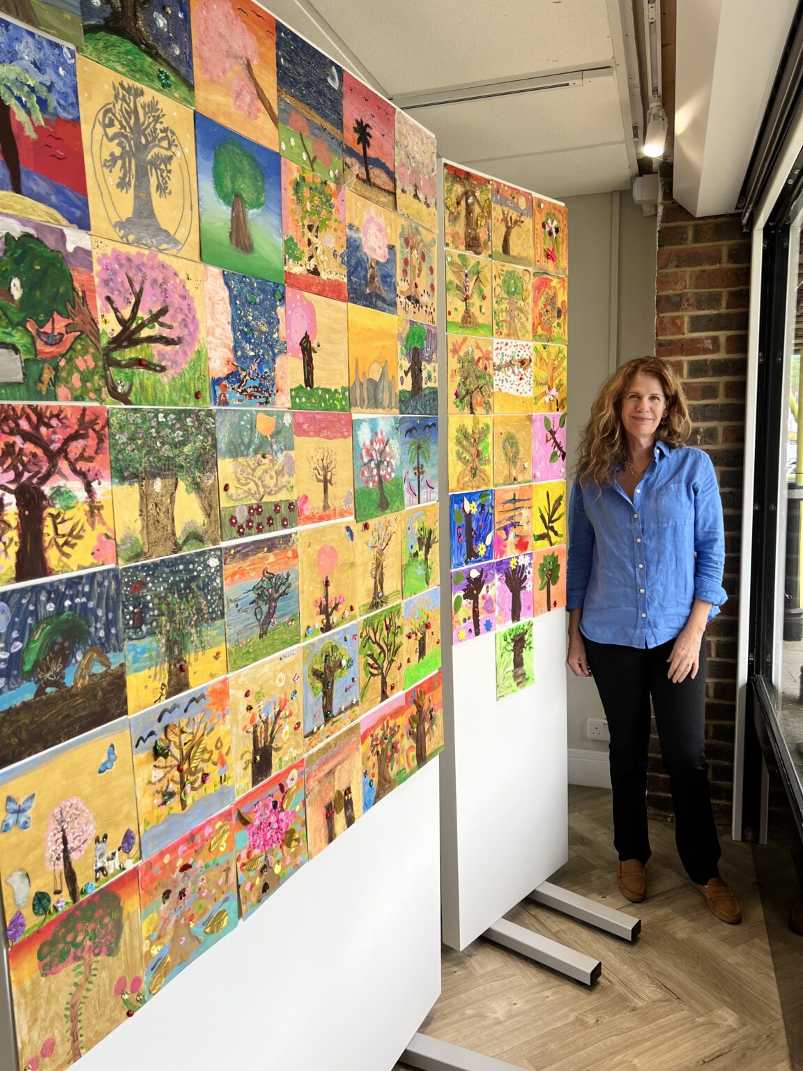 Art in the community, Artist Amanda Padfield stood next to artwork by the school children
