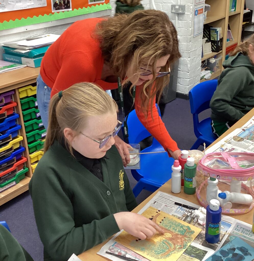 Art in the community, Amanda Padfield helping a school child with art