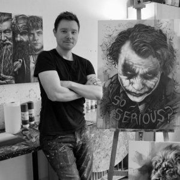 Ben Jeffery Ben Jeffery, black and white photograph of the artist standing next to a piece of artwork
